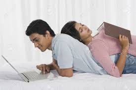 Man Using A Laptop With His Girlfriend Sleeping On His Back Stock rlHh4S VjtHvtM